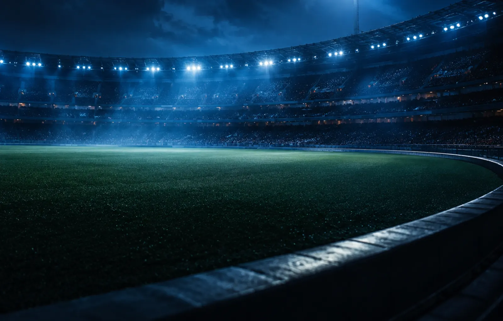 A floodlit stadium at night.