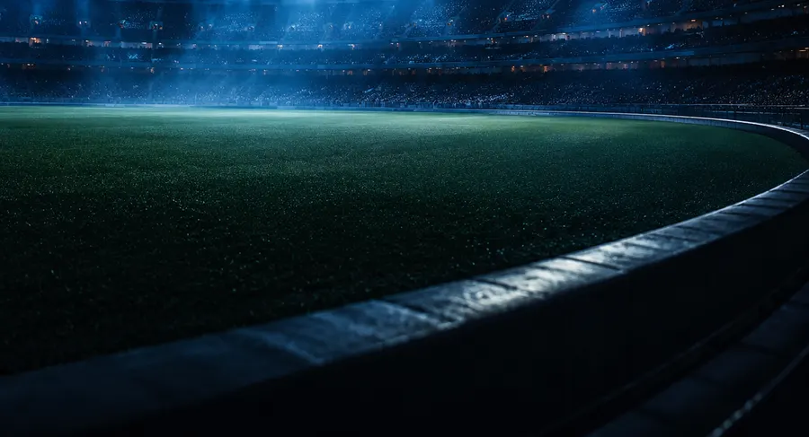 A floodlit stadium at night.